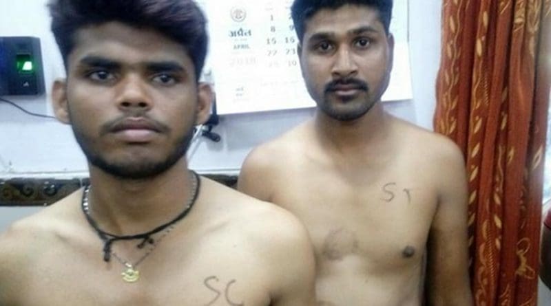 Two young men aspiring to become police constables have their caste identities written on their bare chests in Madhya Pradesh. (Photo by Narendra Teniwal/ucanews.com)