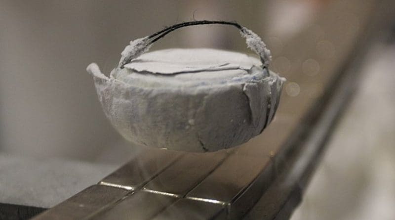 A high-temperature superconductor levitating above a magnet. Photo by Henry Mühlpfordt, Wikipedia Commons.
