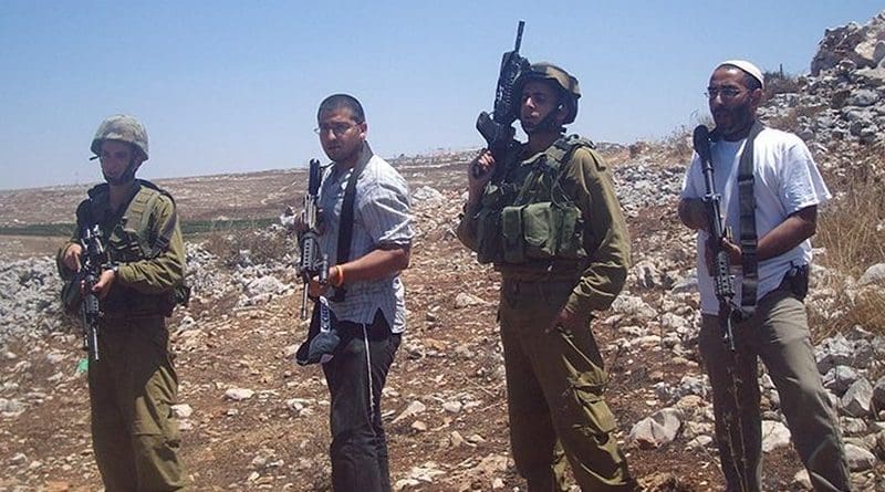 IDF soldiers and Israeli settlers. Photo by ISM Palestine, Wikimedia Commons.