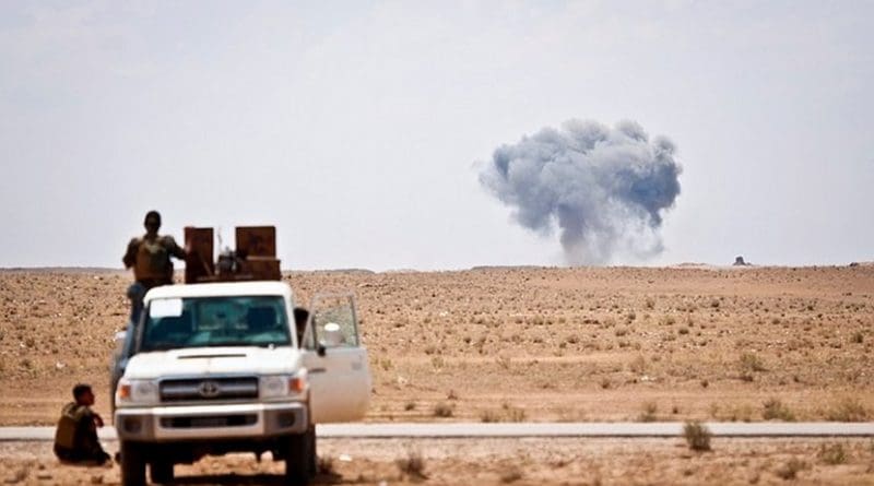 Syrian Democratic Forces watch as a coalition airstrike hits its target on a known Islamic State of Iraq and Syria location near the Iraq-Syria border, May 13, 2018. The SDF forces provided security for a coalition mortar team and were postured to offer quick response force services if needed. The strike was in support of Operation Roundup, the offensive to eliminate pockets of ISIS fighters in the Middle Euphrates River Valley in Syria. DoD photo by Army Staff Sgt. Timothy R. Koster