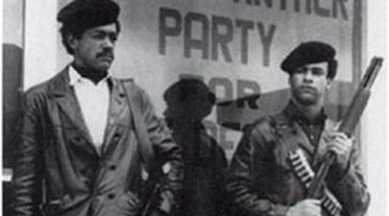 Black Panther members Huey Newton and Bobby Seale standing in streets, armed with shotguns. Source: Wikipedia Commons.