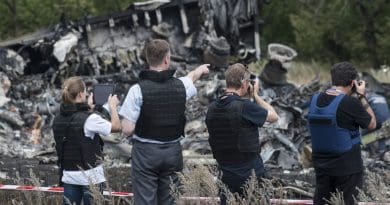 Members of the Organization for Security and Cooperation in Europe (OSCE) Special Monitoring Mission to Ukraine examine the MH17 crash site in July 2014. Photo Credit: OSCE/Evgeniy Maloletka