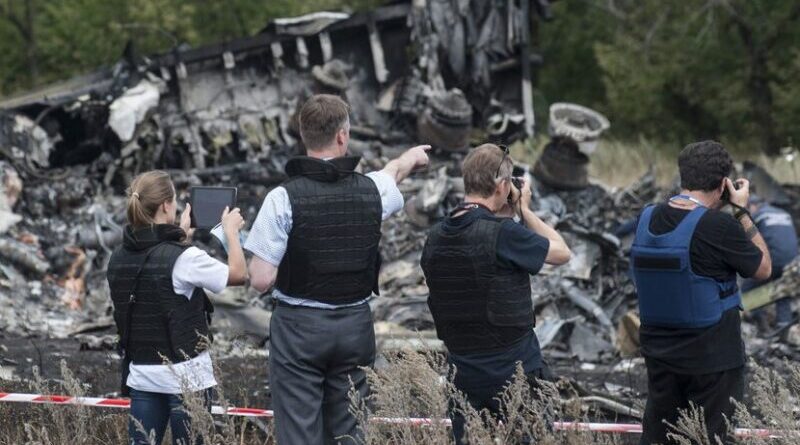 Members of the Organization for Security and Cooperation in Europe (OSCE) Special Monitoring Mission to Ukraine examine the MH17 crash site in July 2014. Photo Credit: OSCE/Evgeniy Maloletka
