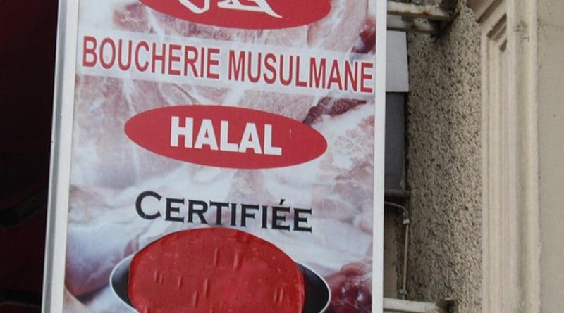 Shop sign in French and Arabic for a halal butcher's shop. Photo by Mu, Wikimedia Commons.