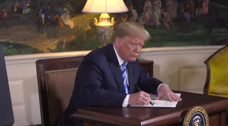 US President Donald Trump signs a Presidential Memorandum on the Iran nuclear deal. Photo Credit: White House video screenshot.