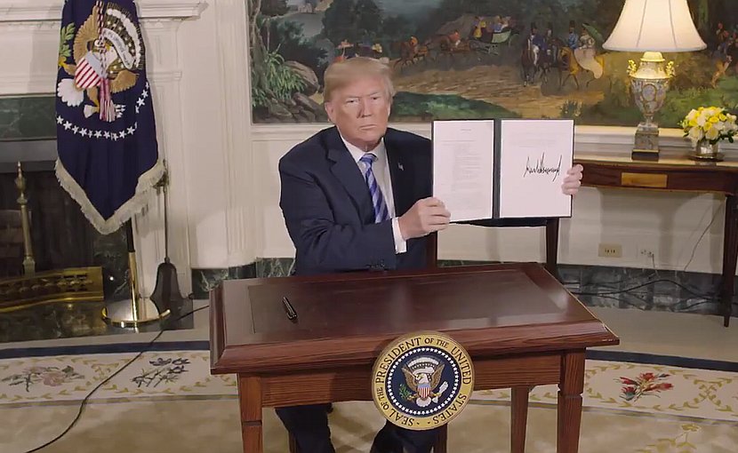 US President Donald Trump signs a Presidential Memorandum on the Iran nuclear deal. Photo Credit: White House video screenshot.