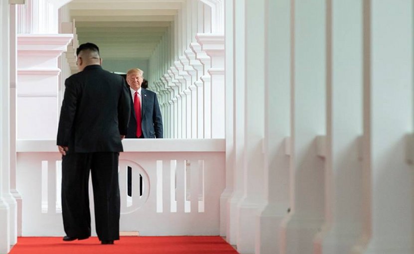 President Donald J. Trump watches as North Korean leader Kim Jong Un, walks toward him for their first-ever meeting, Tuesday, June 12, 2018, at the Capella Hotel in Singapore. (Official White House Photo by Stephanie Chasez)