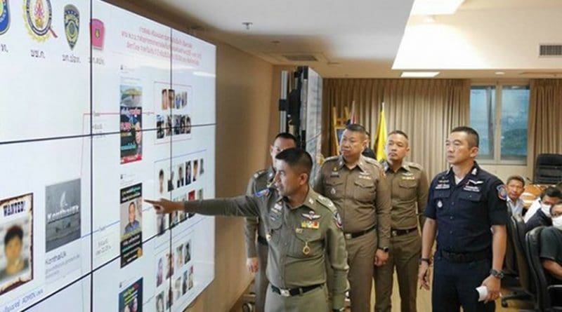 Police Maj. Gen. Surachate Hakpal points at a chart showing Facebook posts while other police officers look on at the computer crimes office in Bangkok, June 12, 2018. Courtesy Royal Thai Police