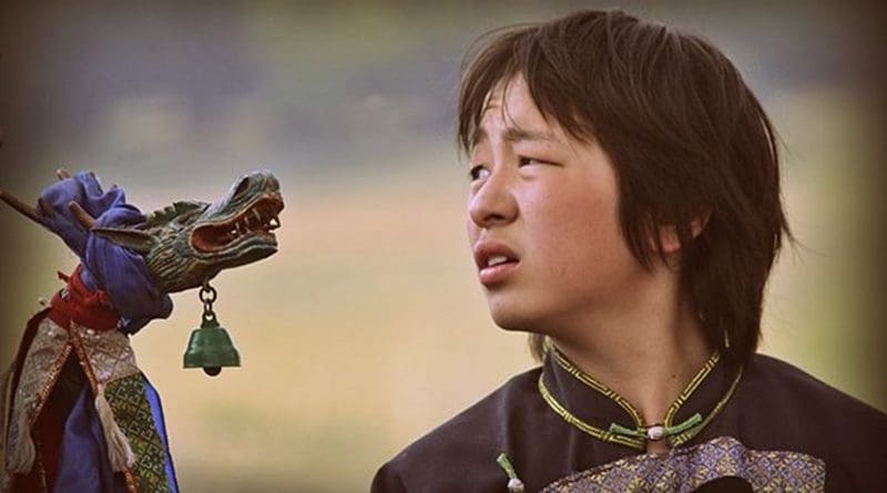 A Buryat boy in a shaman ritual in Siberia, Russia. Photo Credit: Аркадий Зарубин, Wikimedia Commons.