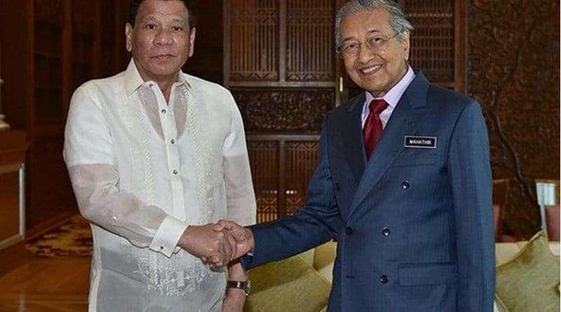 Malaysia Prime Minister Mahathir Mohamad (right), shakes hands with Philippine President Rodrigo Duterte during their meeting in Putrajaya, July 16, 2018. Malaysian Department of Information/