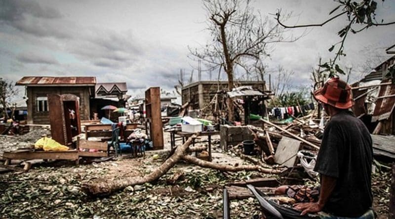 A man looks at the remains of his home after Typhoon Mangkhut slammed through Cagayan province, the Philippines, Sept. 16, 2018. Photo Credit: Karl Romano/BenarNews