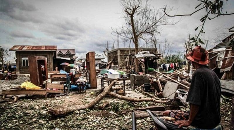 A man looks at the remains of his home after Typhoon Mangkhut slammed through Cagayan province, the Philippines, Sept. 16, 2018. Photo Credit: Karl Romano/BenarNews