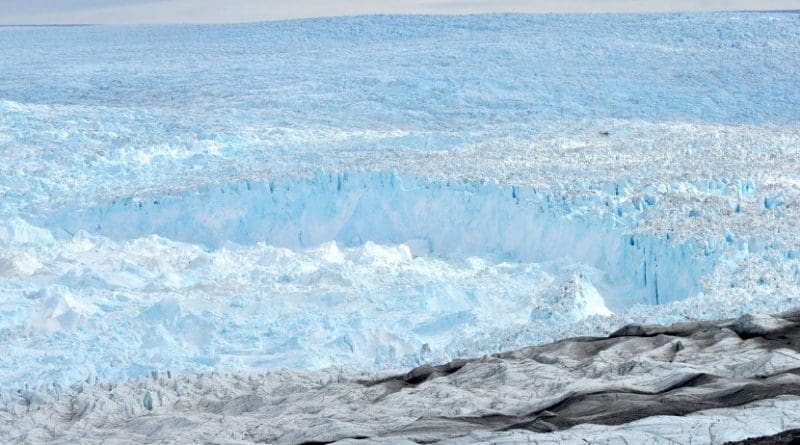 Jakobshavn Isbrae during Cassotto's 2012 field campaign. Look closely, a 19-seater tourist helicopter hovers above the ice. Credit Ryan Cassotto/CIRES and CU Boulder