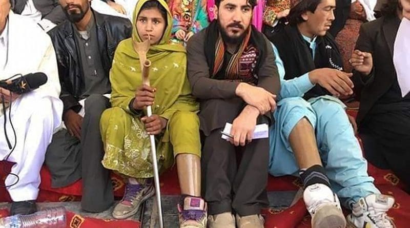 Manzoor Pashteen (center) sitting with landmine victims in Tank, Khyber Pakhtunkhwa, Pakistan, at a PTM gathering on the first anniversary of the murder of Naqeebullah Mehsud. Photo Credit: Khestwol, Wikipedia Commons.