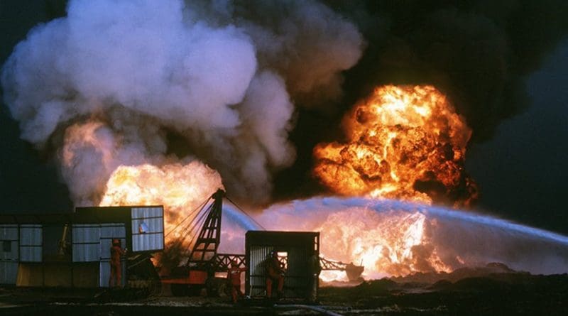 Personnel from Santa Fe Drilling Company and Red Adair Oil Well firefighters battle blaze from burning oil well set afire by Iraqi forces prior to their retreat from Kuwait during Operation Desert Storm (DOD/Dick Moreno)