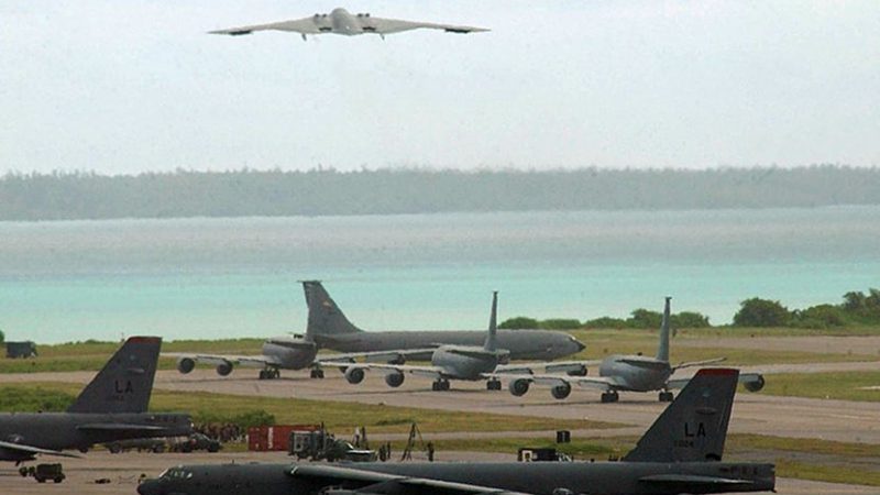 A B-2 bomber takes off, with B-52 bombers on tarmac on Diego Garcia. Photo Credit: U.S. Air Force photo by Senior Airman Nathan G. Bevier