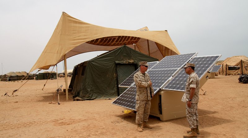 Maj. Sean M. Sadlier (left) of the U.S. Marine Corps Expeditionary Energy Office explains the solar power element of the Expeditionary Forward Operating Base concept to Col. Anthony Fernandez during the testing phase of this sustainable energy initiative. May 19, 2010. (by U.S. Marine Corps/Maj. Paul Greenberg)