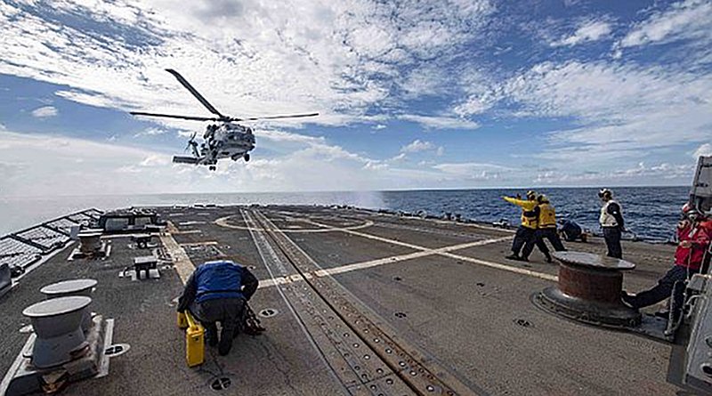 An MH-60R Sea Hawk helicopter assigned to the Saberhawks of Helicopter Maritime Strike Squadron (HSM) 77 lands on the flight deck aboard the Arleigh Burke-class guided-missile destroyer USS McCampbell (DDG 85). McCampbell is forward-deployed to the U.S. 7th Fleet area of operations in support of security and stability in the Indo-Pacific region. (U.S. Navy photo by Mass Communication Specialist 3rd Class Isaac Maxwell/Released)