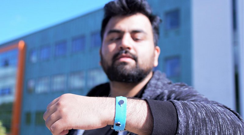 Co-creator Muhammad Umair wearing one of the prototype smart materials wrist bands. Credit Paul Turner/Lancaster University