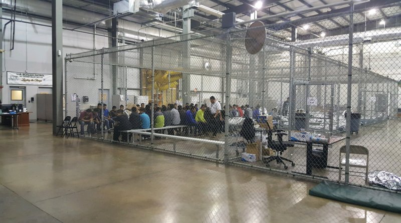 Young persons sitting within a wire mesh compartment in the Ursula detention facility in McAllen, Texas. Photo Credit: US Customs and Border Patrol