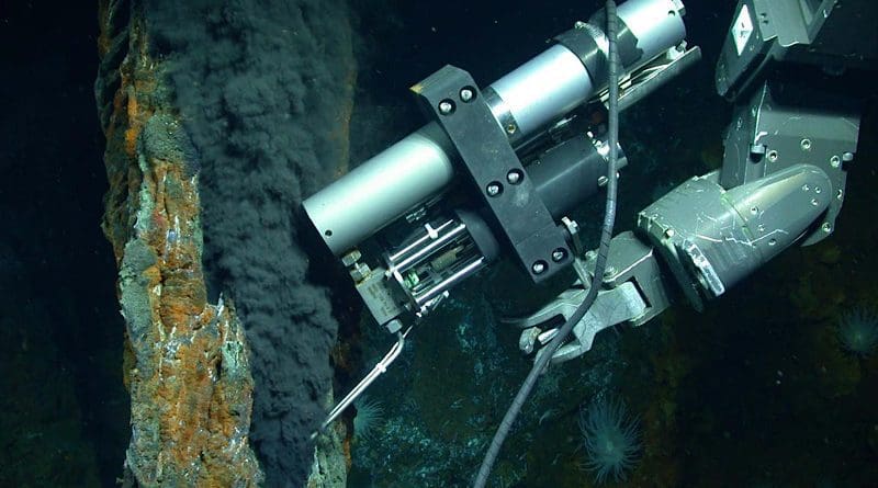 The manipulator arm of the remotely operated vehicle Jason samples a stream of fluid from a hydrothermal vent. The fluid contains gases that are in liquid form because of the high pressure of the deep ocean. CREDIT Photo by Chris German/WHOI/NSF, NASA/ROV Jason 2012, © Woods Hole Oceanographic Institution