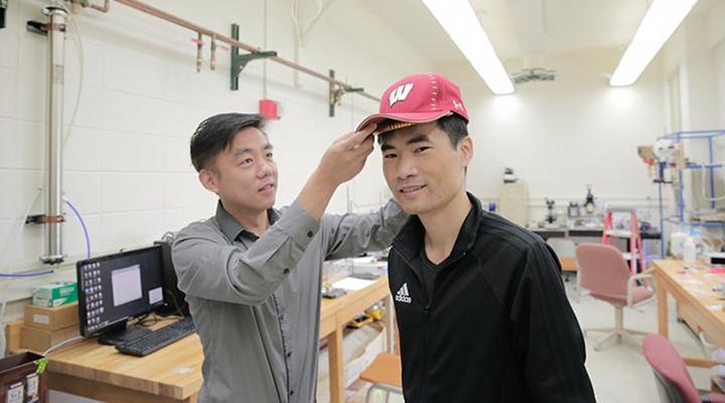 UW-Madison Materials Science and Engineering Professor Xudong Wang (left) and colleagues developed an device -- unobtrusive enough to fit under a cap -- that harnesses energy from the wearer and delivers gentle electric pulses to stimulate dormant hair follicles and regrow hair. Credit UW-Madison photo by Sam Million-Weaver.