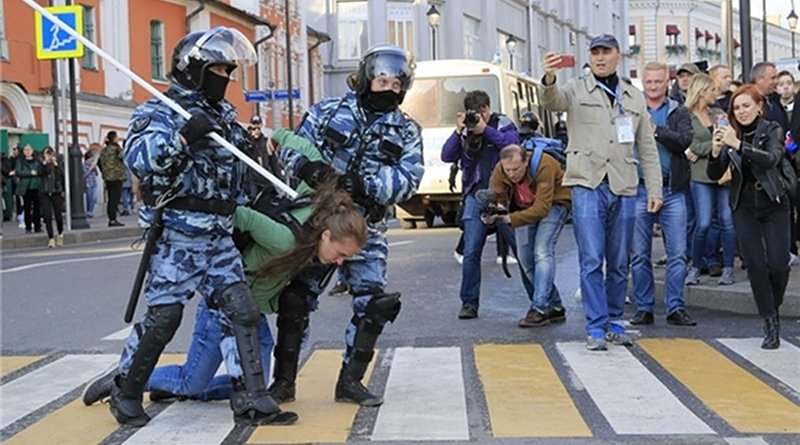 Russian security forces arrest woman protestor in Moscow, Russia. Photo Credit: Fars News Agency