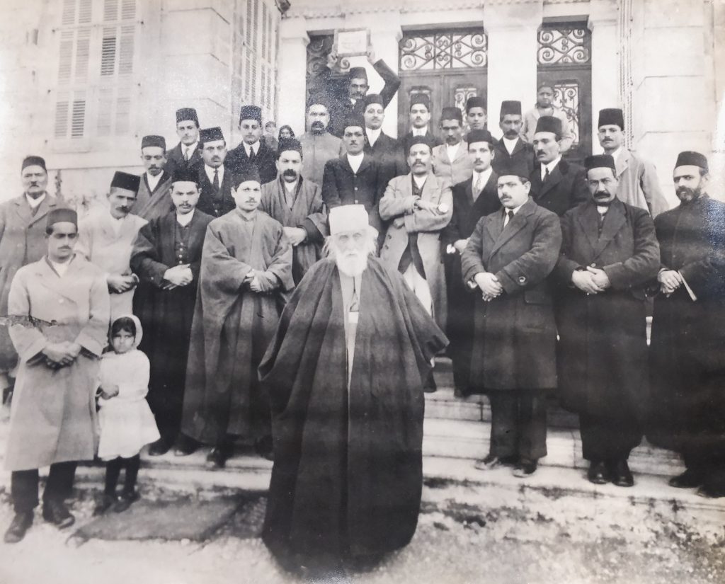 Guardian  of the Faith, Abdul Baha (centre), surrounded by Indian and local  Baha’is on the steps of his home in Bahji, near Haifa.