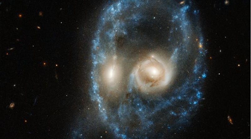 This new image from the NASA/ESA Hubble Space Telescope captures two galaxies of equal size in a collision that appears to resemble a ghostly face. This observation was made on 19 June 2019 in visible light by the telescope's Advanced Camera for Surveys. Residing 704 million light-years from Earth, this system is catalogued as Arp-Madore 2026-424 (AM 2026-424) in the Arp-Madore "Catalogue of Southern Peculiar Galaxies and Associations". CREDIT NASA, ESA, J. Dalcanton, B.F. Williams, and M. Durbin (University of Washington)