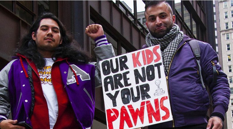 Two striking Chicago teachers hold a sign stating, "Our kids are not your pawns." Photo credit: Charles Edward Miller. This image has been cropped and modified for size. CC BY-SA 2.0.