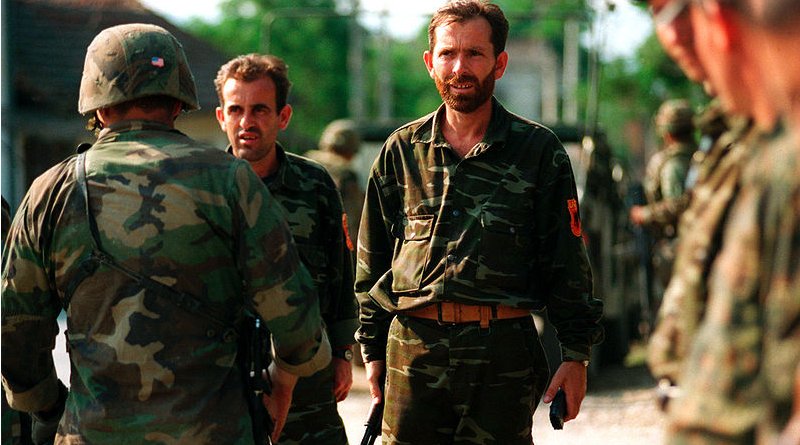 Members of the Kosovo Liberation Army turn over their weapons to U.S. Marines. DoD photo by Sgt. Craig J. Shell, U.S. Marine Corps