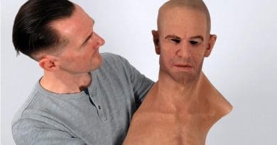 Dr. Rob Jenkins holds a hyper-realistic mask. CREDIT University of York