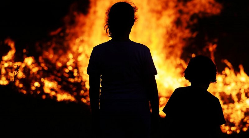 Children Standing in Front of a Fire. CREDIT Shutterstock/Zurijeta
