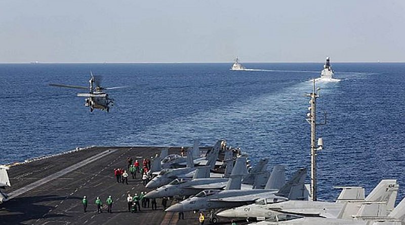 The aircraft carrier USS Abraham Lincoln (CVN 72) transits the Strait of Hormuz as an MH-60S Sea Hawk helicopter from the Nightdippers of Helicopter Sea Combat Squadron (HSC) 5 lifts off from the flight deck. (U.S. Navy photo by Mass Communication Specialist Seaman Stephanie Contreras/Released)