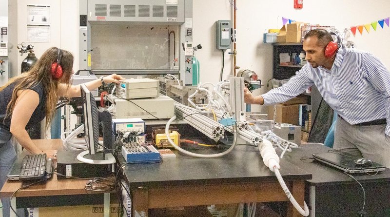 Jessica Chambers, a doctoral student in the University of Central Florida's Department of Mechanical and Aerospace Engineering, and Kareem Ahmed, an assistant professor in UCF's Department of Mechanical and Aerospace Engineering, set up the turbulent shock tube they used to help uncover the mechanisms that could have caused the Big Bang. Credit Karen Norum, UCF Office of Research