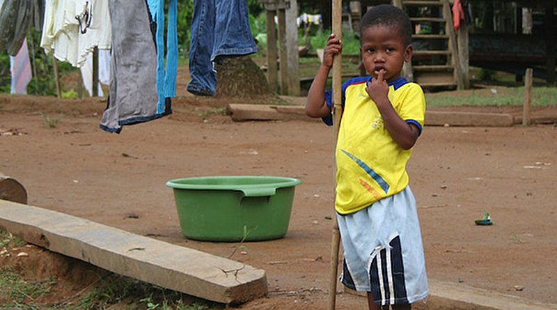 A child stands in front of his house in Cayapas, Ecuador. In this area community schools have been set up by UNICEF in partnership with the local Catholic church, to provide basic quality education to children living in this remote area, where the vast majority of the population is Afro-descendant. Credit: UNICEF | Donata Lodi.