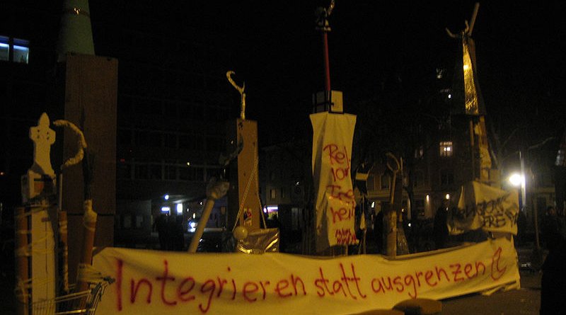 On the evening of the vote, demonstrations against the result were held in Switzerland's major cities. The banner beneath the makeshift minarets reads: "Integrate rather than exclude." Photo Credit: MCaviglia, Wikipedia Commons