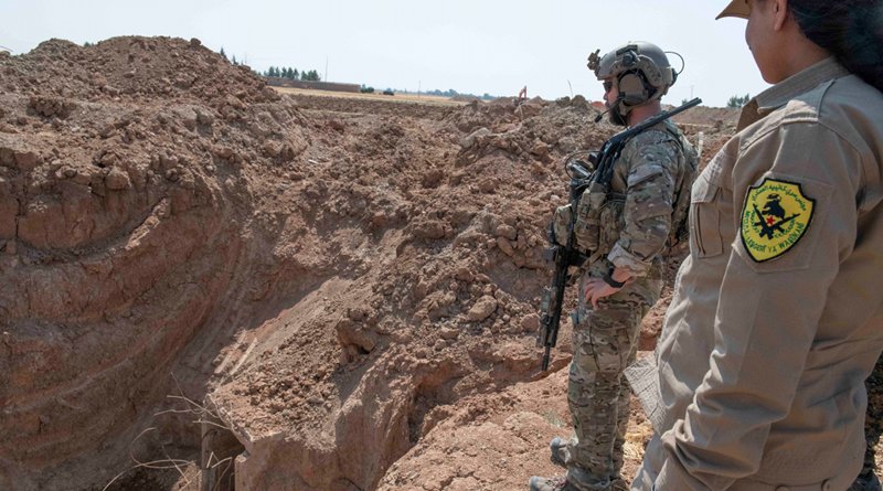 A member of the U.S.-led coalition and a member of a local security force observe the destruction of a former fortification in northern Syria. Photo Credit: Army Staff Sgt. Andrew Goedl