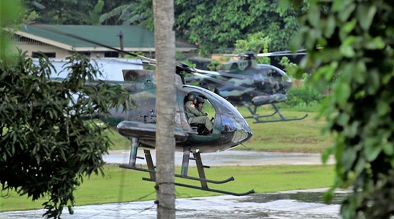 Two attack helicopters from the Philippine military reload missiles as their crews prepare to resume an assault on Abu Sayyaf militant positions Jolo island, an island in the southern Philippines, in April 2019. [Mark Navales/BenarNews]