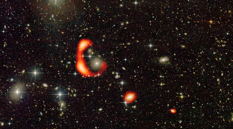 The optical image from the CFHT telescope with the distribution of neutral hydrogen in the form of a large ring shown in red as observed by the GMRT. The other two red blobs show the distribution of neutral hydrogen around two other galaxies which are in the vicinity of the ring. CREDIT O. Bait (NCRA-TIFR/GMRT), Duc (ObAS/CFHT)