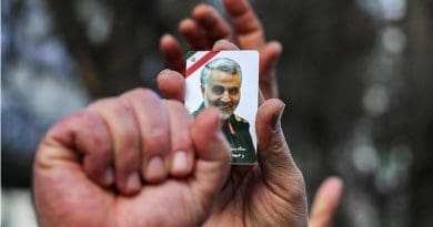 Mourner holds photo of commander of the Quds Force of the Islamic Revolution Guards Corps (IRGC), Qassem Soleimani. Photo Credit: Tasnim News Agency
