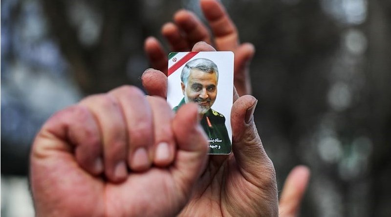 Mourner holds photo of commander of the Quds Force of the Islamic Revolution Guards Corps (IRGC), Qassem Soleimani. Photo Credit: Tasnim News Agency