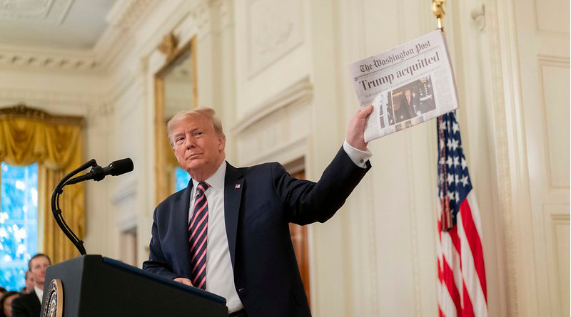 President Donald J. Trump shows a newspaper headline during his address Thursday, Feb. 6, 2020 in the East Room of the White House, in response to being acquitted in the U.S. Senate Impeachment Trial. (Official White House Photo by D. Myles Cullen)