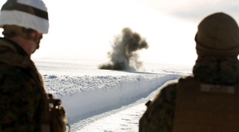 Two service members watch an explosion in Rena, Norway, in advance of Exercise Cold Response 2016, Feb. 22, 2016. Photo Credit: Marine Corps Lance Cpl. Brianna Gaudi