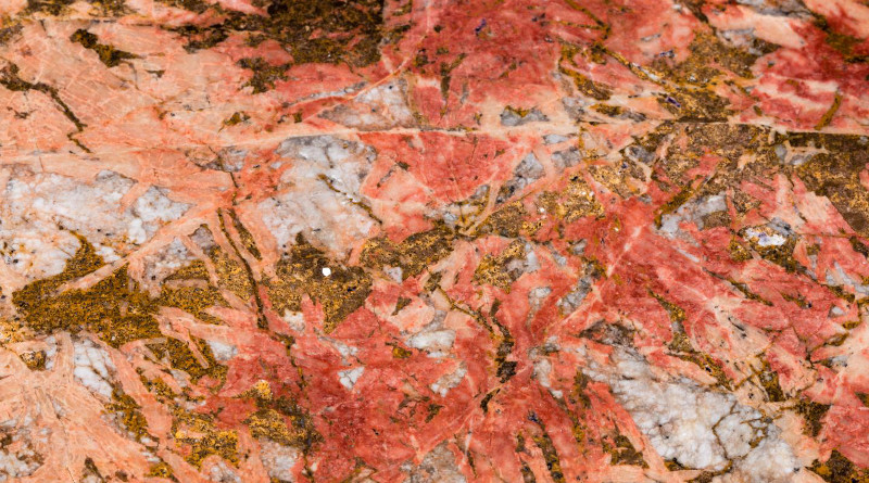 Bastnaesite (the reddish parts) in Carbonatite. Bastnaesite is an important ore for rare earth elements, one of the mineral commodities identified as most at-risk of supply disruption by the USGS in a new methodology. CREDIT Scott Horvath, USGS