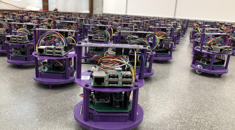One hundred small robots line up in the laboratory. CREDIT Northwestern University