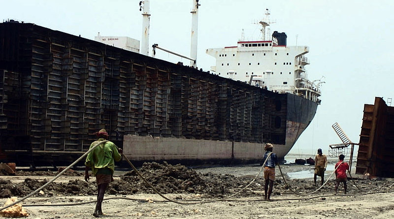 Workers drag steel plate ashore from beached ships in Chittagong, Bangladesh. Photo Credit: Stéphane M Grueso, Wikipedia Commons