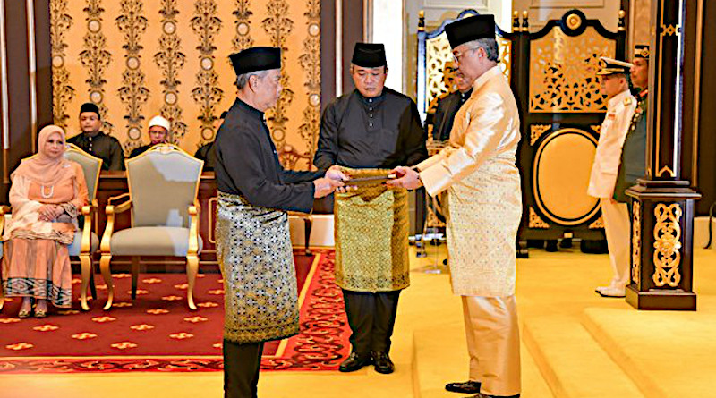 Incoming Malaysian Prime Minister Muhyiddin Yassin (left) receives documents from King Al-Sultan Abdullah Ri’ayatuddin Al-Mustafa Billah before taking the oath of office at the National Palace in Kuala Lumpur, March 1, 2020. Courtesy Malaysia Information Department