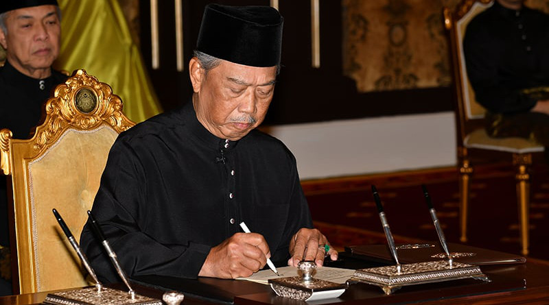 Malaysia's Muhyiddin Yassin signs document in swearing-in ceremony to become Prime Minister. Photo Credit: Malaysia Information Department