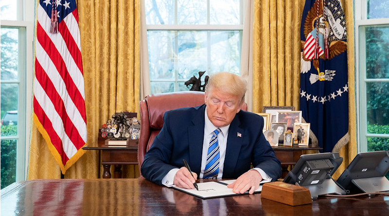 President Donald J. Trump signs a Presidential Memorandum in the Oval Office of the White House, Wednesday, March 11, 2020, for the Secretary of Health and Human Services and the Secretary of Labor on making general use face masks available to our healthcare workers. (Official White House Photo by Tia Dufour)